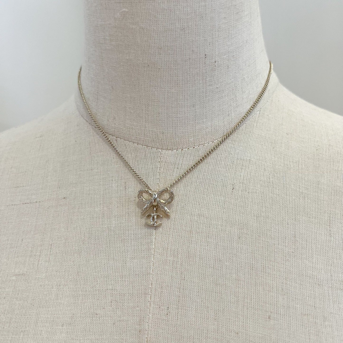 Chanel Bow and Dangling Logo Necklace in SHW (Model: )