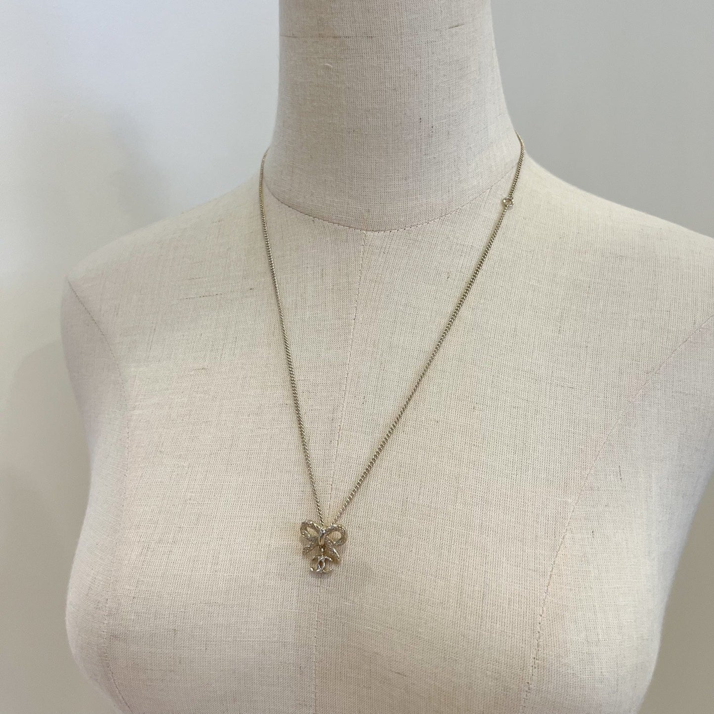Chanel Bow and Dangling Logo Necklace in SHW (Model: )